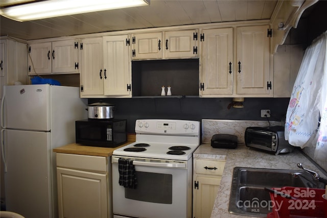 kitchen with sink and white appliances