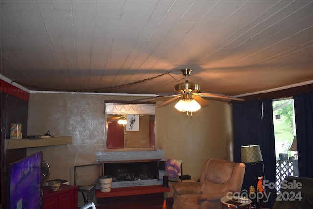 living room featuring ornamental molding and ceiling fan