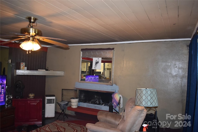 living room with ceiling fan and wood ceiling