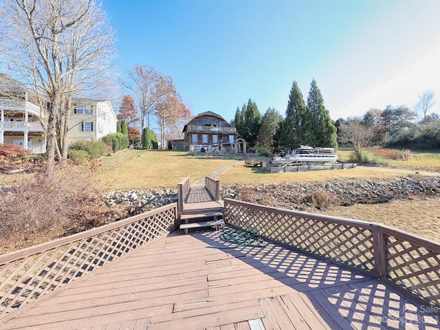 wooden terrace featuring a yard