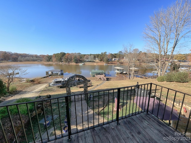 wooden terrace featuring a water view