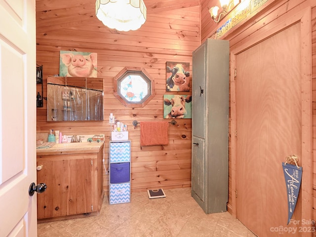 bathroom featuring wood walls