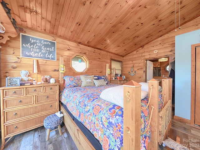 bedroom with wooden ceiling, dark hardwood / wood-style flooring, wood walls, and vaulted ceiling