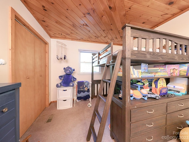 carpeted bedroom featuring wooden ceiling, a closet, and vaulted ceiling