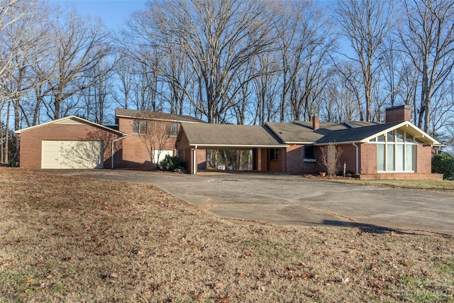 3616 County Home Rd, Conover, NC 28613 - view of front facade featuring an attached carport, brick siding, concrete driveway, and a chimney