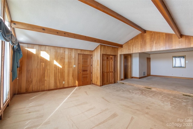 3616 County Home Rd, Conover, NC 28613 - additional living space featuring a textured ceiling, wooden walls, lofted ceiling with beams, and carpet