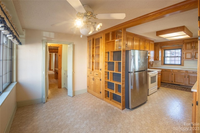 3616 County Home Rd, Conover, NC 28613 - kitchen featuring baseboards, ceiling fan, light countertops, freestanding refrigerator, and electric stove