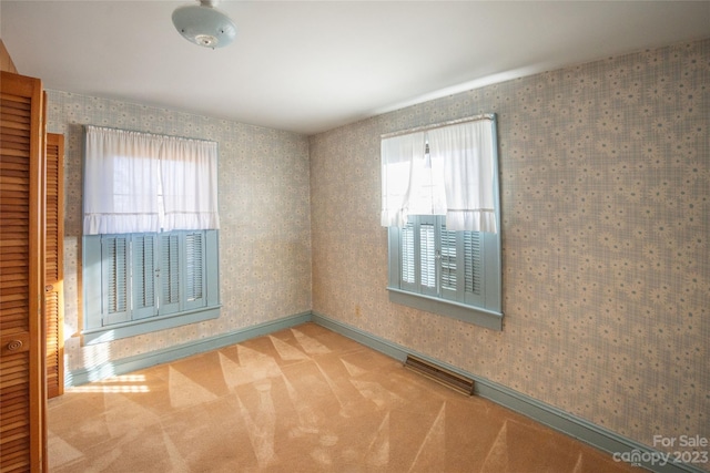 3616 County Home Rd, Conover, NC 28613 - carpeted empty room featuring visible vents, a healthy amount of sunlight, and wallpapered walls