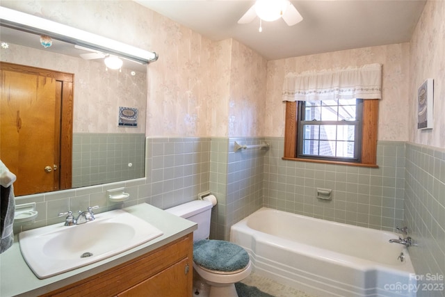 full bathroom featuring tile walls, decorative backsplash, toilet, vanity, and ceiling fan