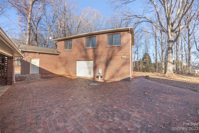 rear view of house with a garage