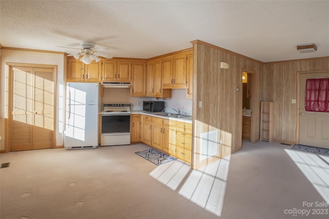 kitchen with exhaust hood, white appliances, light carpet, and ceiling fan