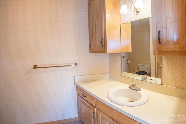 bathroom featuring toilet and vanity