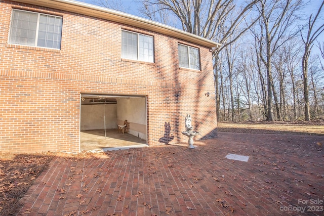 3616 County Home Rd, Conover, NC 28613 - rear view of house featuring a patio, a garage, and brick siding