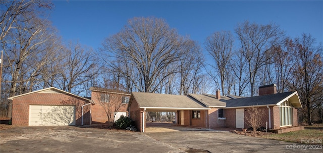 3616 County Home Rd, Conover, NC 28613 - view of front of home featuring concrete driveway, a carport, brick siding, and a chimney
