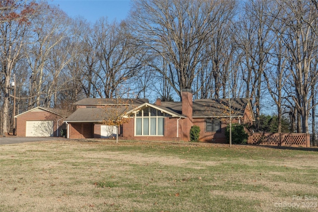 ranch-style house featuring a garage and a front yard