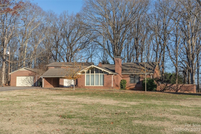 3616 County Home Rd, Conover, NC 28613 - view of front facade featuring an outbuilding, a detached garage, a front yard, brick siding, and a chimney