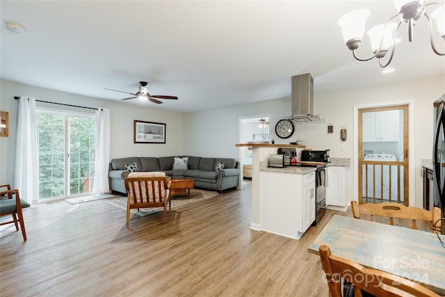 interior space with ceiling fan with notable chandelier, light hardwood / wood-style flooring, and washer / clothes dryer