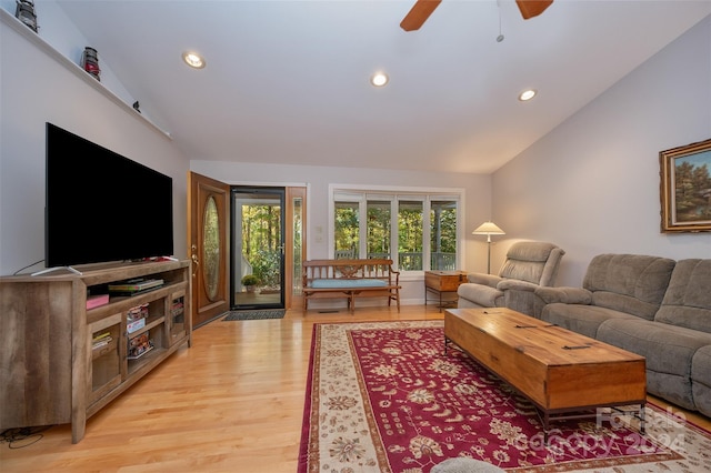 living room with lofted ceiling, light hardwood / wood-style floors, and ceiling fan