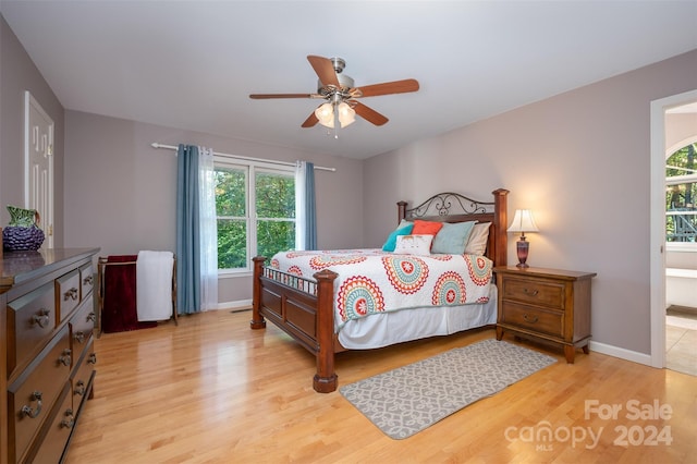 bedroom with multiple windows, ceiling fan, and light wood-type flooring