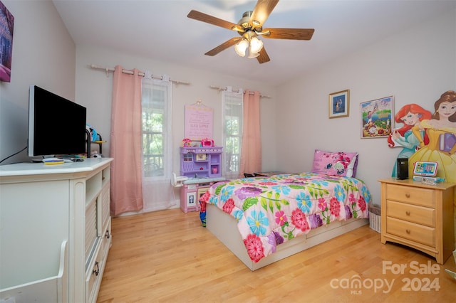 bedroom with light hardwood / wood-style flooring and ceiling fan