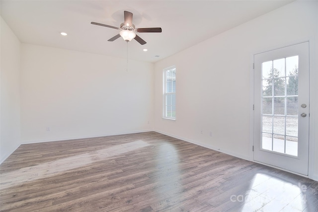 empty room with wood-type flooring and ceiling fan