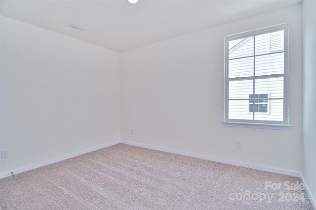 spare room with light colored carpet