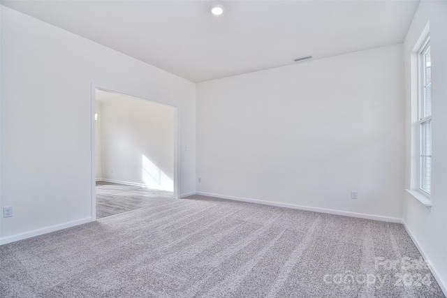 unfurnished room featuring light colored carpet