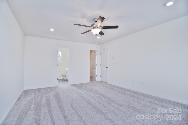 spare room featuring ceiling fan and light colored carpet