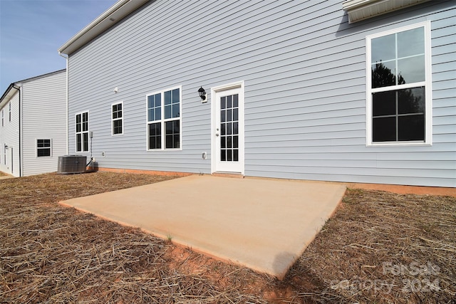 rear view of property featuring cooling unit and a patio area