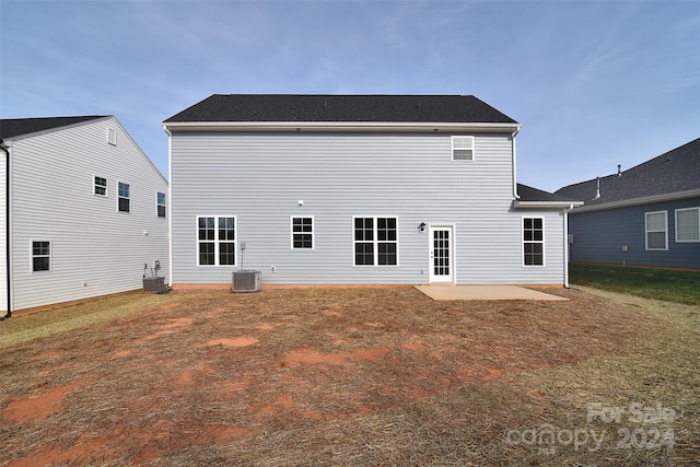 rear view of property featuring cooling unit and a patio area