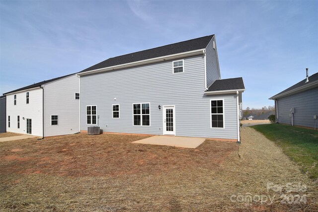 back of property featuring a lawn, central AC, and a patio area