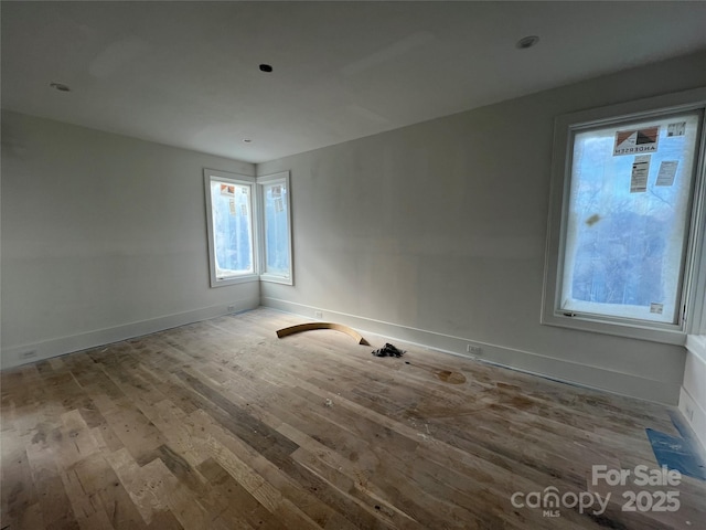 unfurnished room with hardwood / wood-style flooring