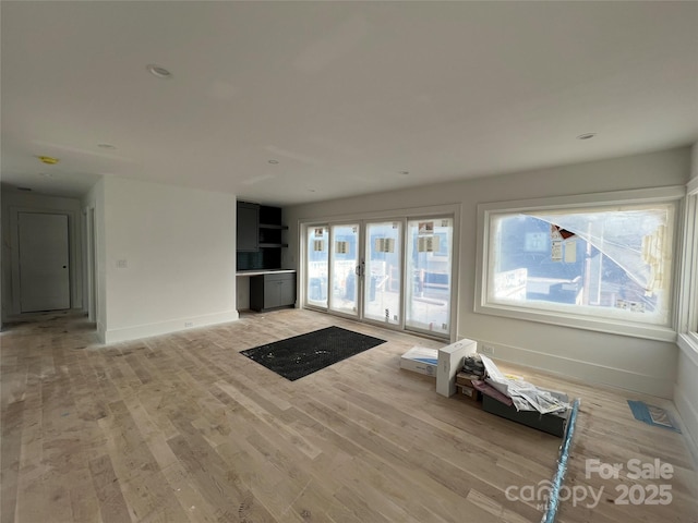 unfurnished living room featuring light hardwood / wood-style flooring