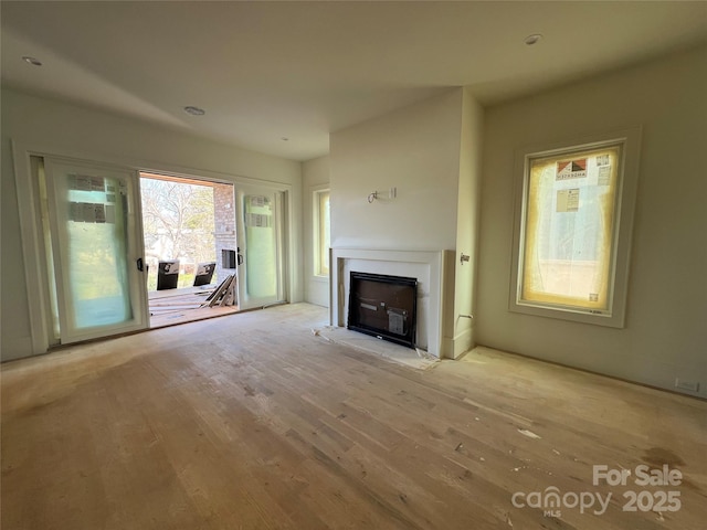 unfurnished living room with light hardwood / wood-style floors