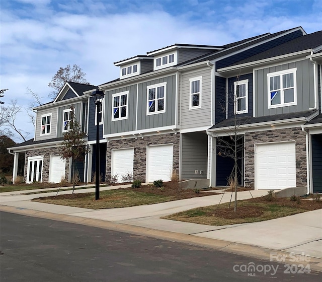 multi unit property featuring a garage