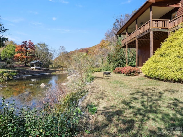 property view of water featuring an outdoor fire pit