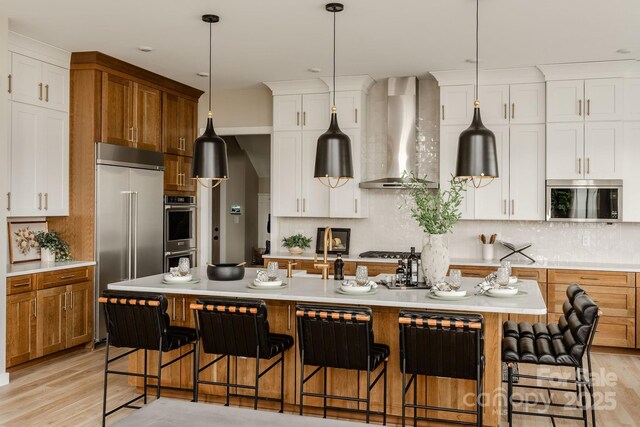 843 Lake Forest Drive Devonshire, Belmont, NC 28012 - kitchen with wall chimney range hood, stainless steel appliances, light countertops, and tasteful backsplash