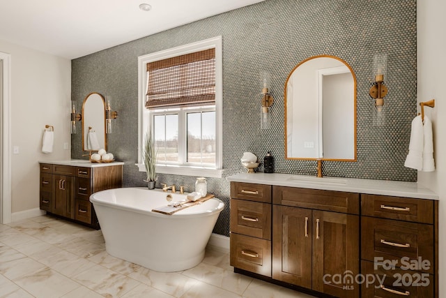 843 Lake Forest Drive Devonshire, Belmont, NC 28012 - bathroom featuring a freestanding tub, vanity, and marble look tiles