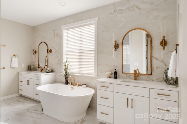 843 Lake Forest Drive Devonshire, Belmont, NC 28012 - bathroom featuring tile walls, a soaking tub, two vanities, marble finish flooring, and healthy amount of natural light