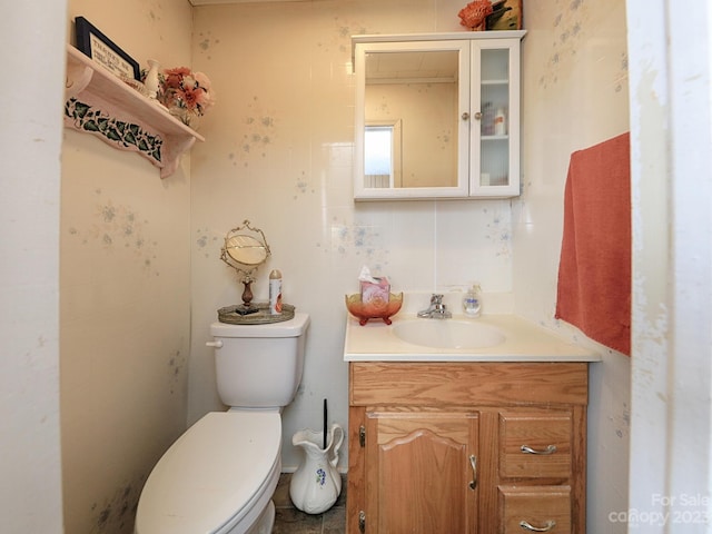 bathroom featuring vanity and toilet