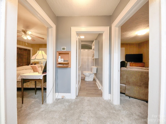 hallway featuring light colored carpet