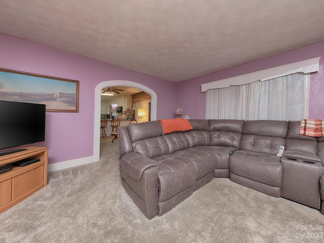 living room with ceiling fan and light colored carpet