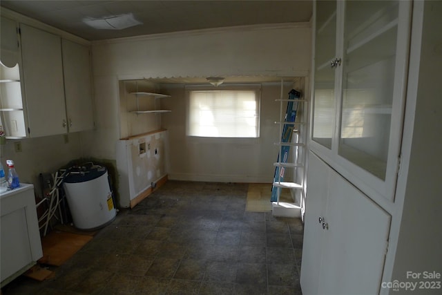 interior space featuring dark tile flooring and white cabinets