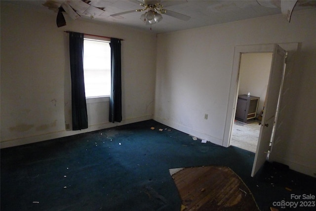 carpeted empty room with ceiling fan