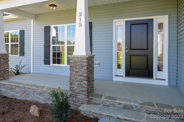 entrance to property featuring covered porch