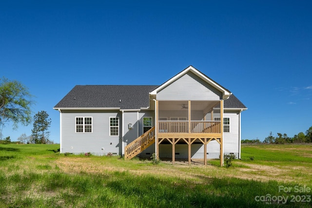 back of property featuring a deck and a yard