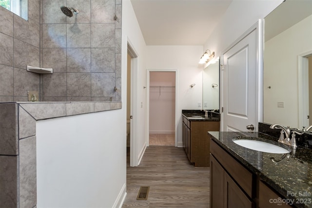 bathroom with dual vanity and wood-type flooring