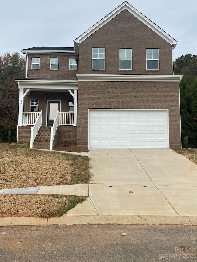 view of front of house featuring a porch and a garage