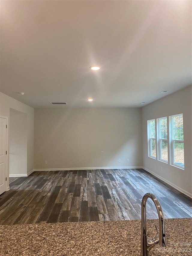 spare room featuring dark wood-type flooring