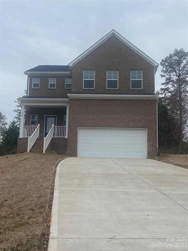 view of front of home with a porch and a garage